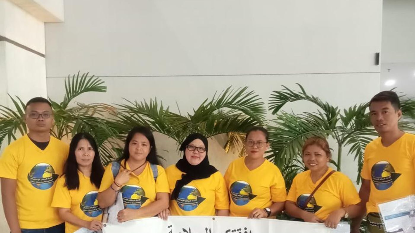 Send-off group holding a safe travels banner